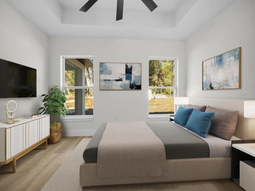 11790 Orange Road Ocklawaha, FL 32179 - Photo 9 of 21 a bedroom with a bed and a flat screen tv