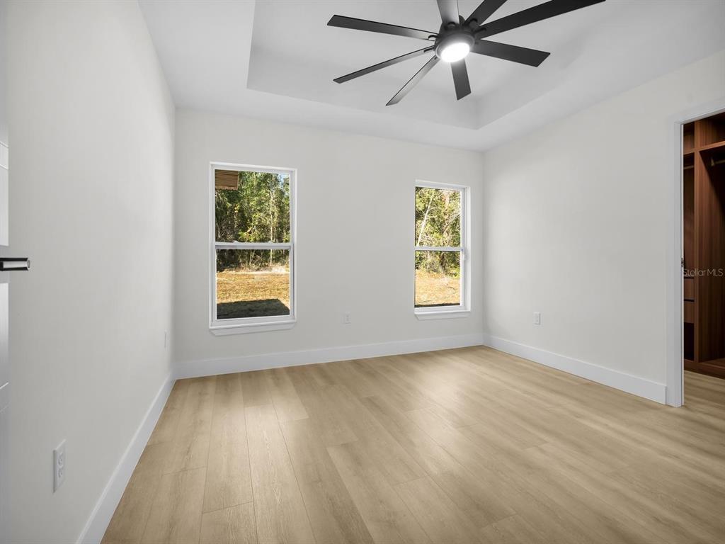 11790 Orange Road Ocklawaha, FL 32179 - Photo 10 of 21 a view of an empty room with wooden floor and a window
