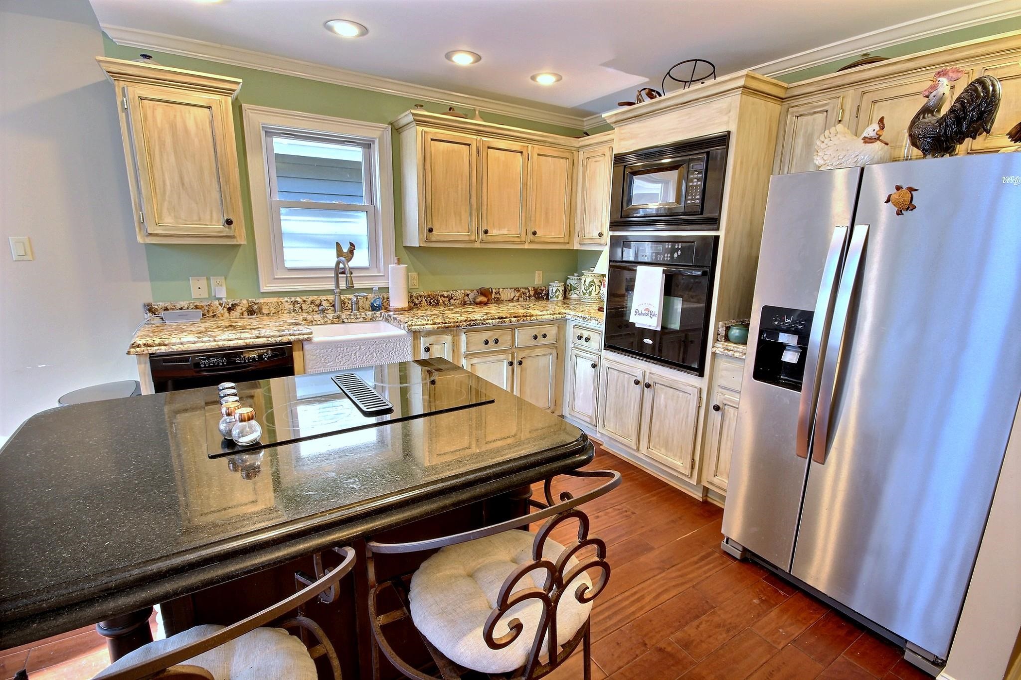 25 Dunhill Court Counce, TN 38326 - Photo 13 of 38 a kitchen with kitchen island a counter top space a sink a refrigerator and a window