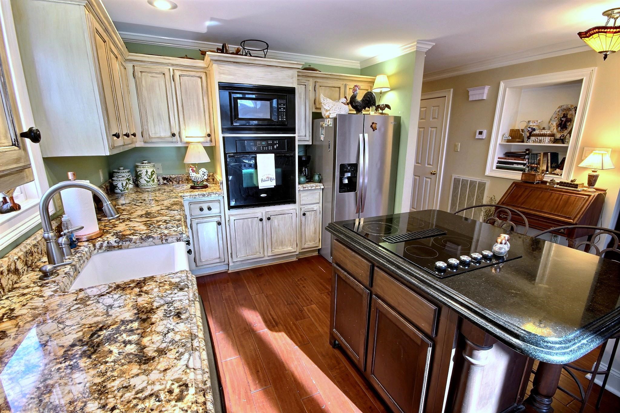25 Dunhill Court Counce, TN 38326 - Photo 14 of 38 a kitchen with granite countertop a stove a sink and a refrigerator
