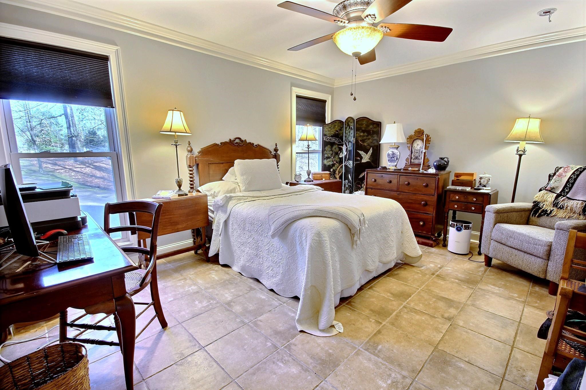 25 Dunhill Court Counce, TN 38326 - Photo 16 of 38 a bedroom with a bed a chandelier and a fireplace