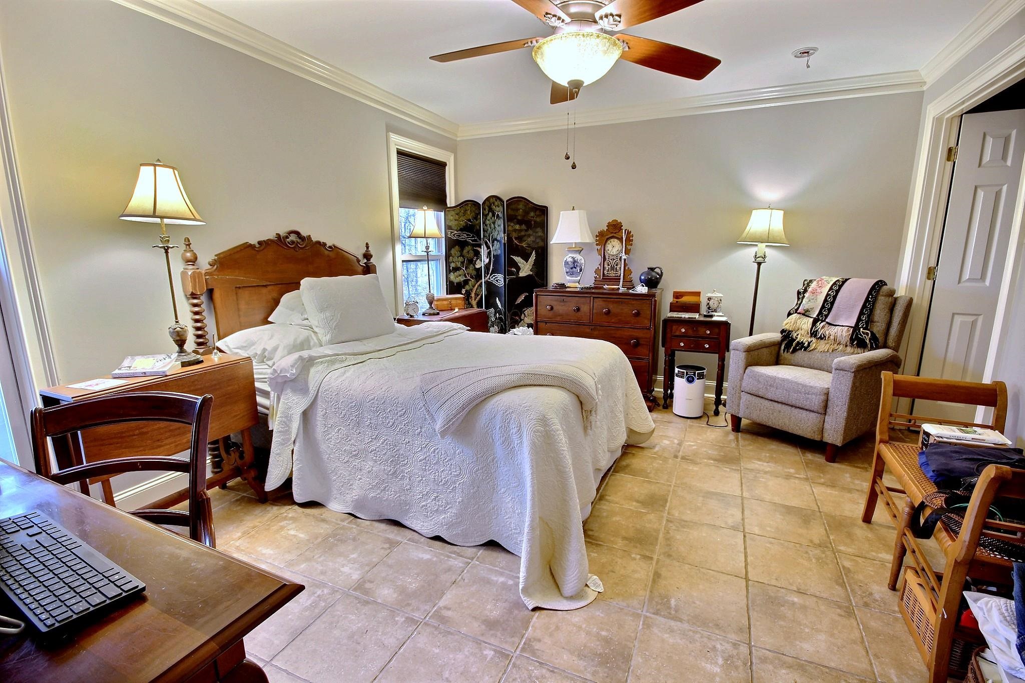 25 Dunhill Court Counce, TN 38326 - Photo 17 of 38 a bedroom with a bed gym equipment and a lamp on dresser