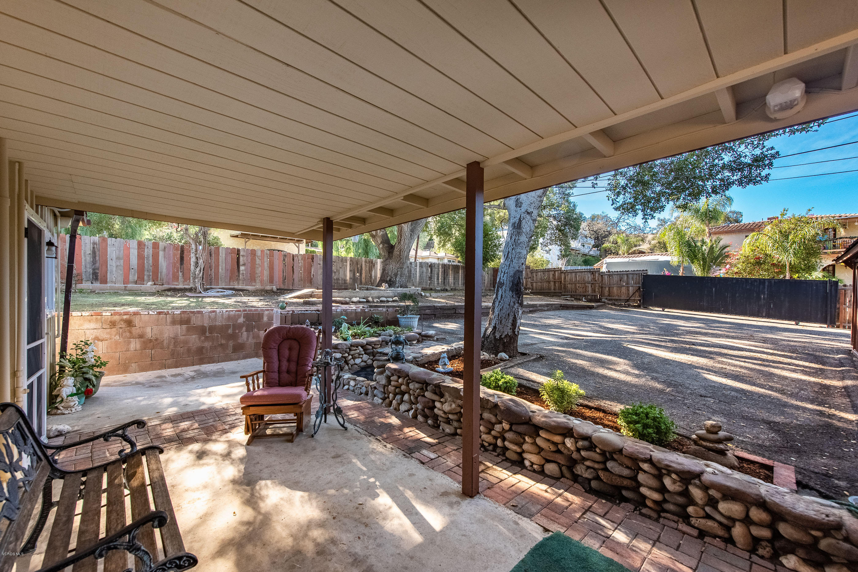 823 Katherine Road Simi Valley, CA 93063 - Photo 15 of 25 a view of a patio with table and chairs barbeque potted plants and large tree