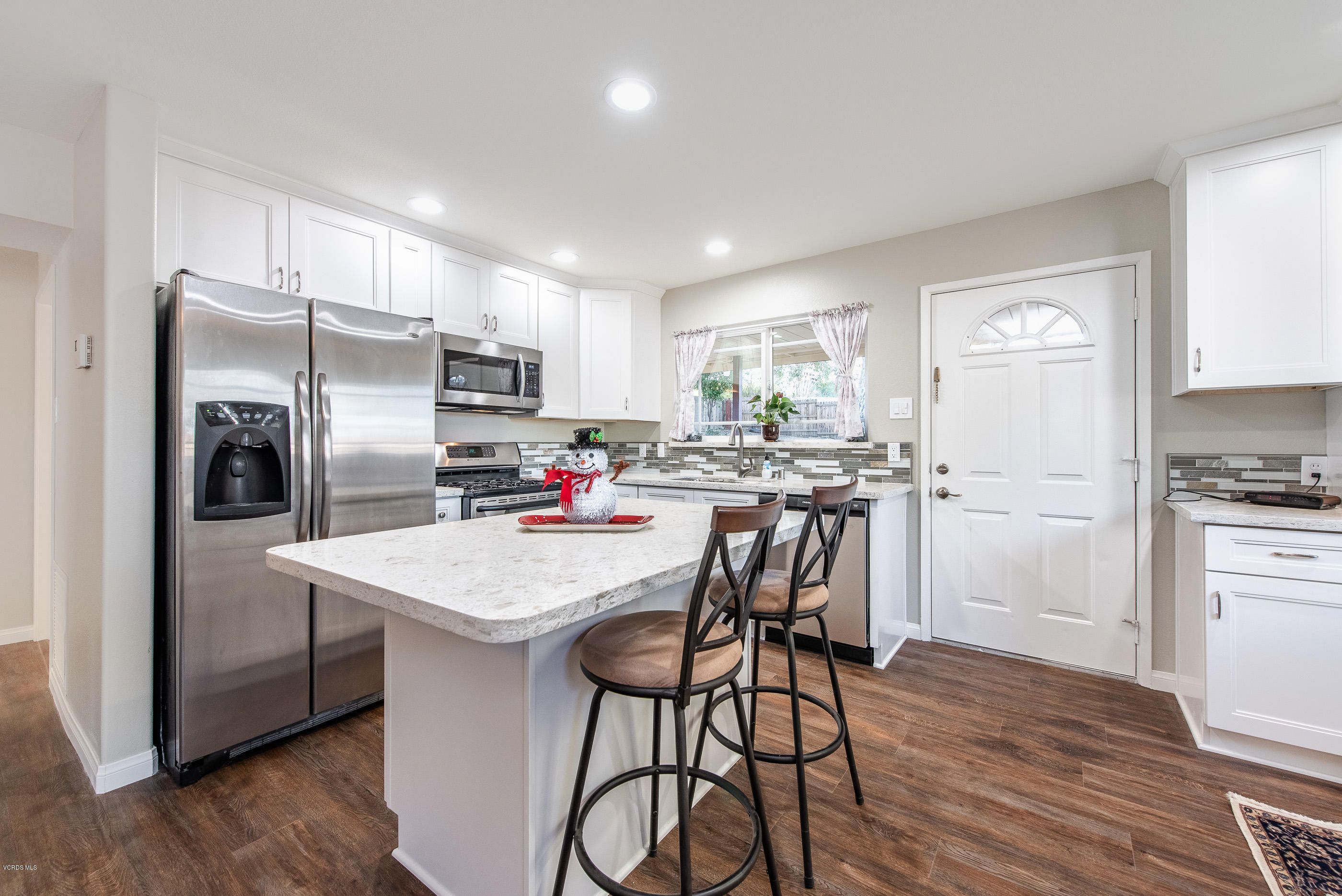 823 Katherine Road Simi Valley, CA 93063 - Photo 5 of 25 a kitchen with refrigerator cabinets dining table and chairs