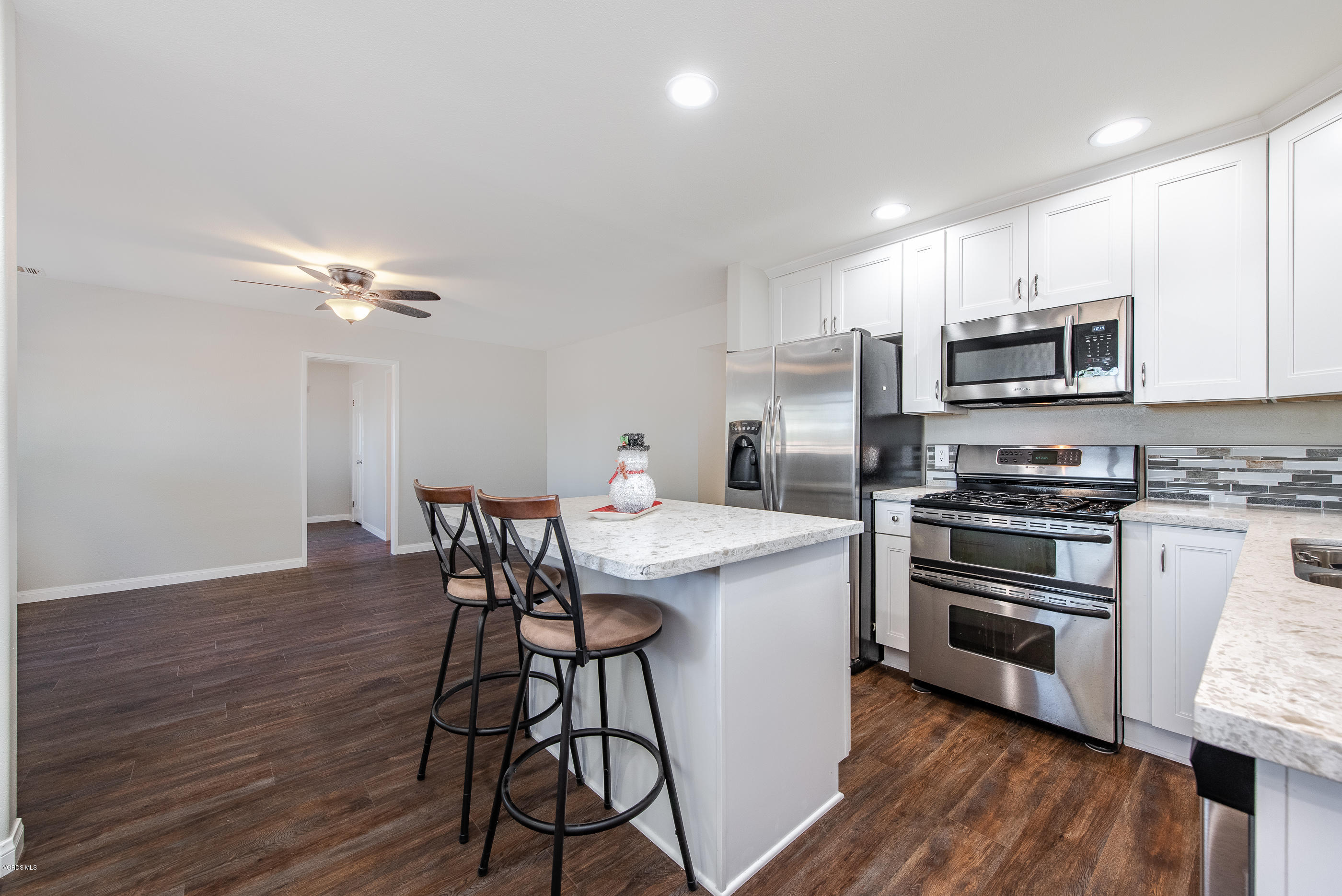 823 Katherine Road Simi Valley, CA 93063 - Photo 6 of 25 a kitchen with stainless steel appliances a kitchen island hardwood floor and a sink