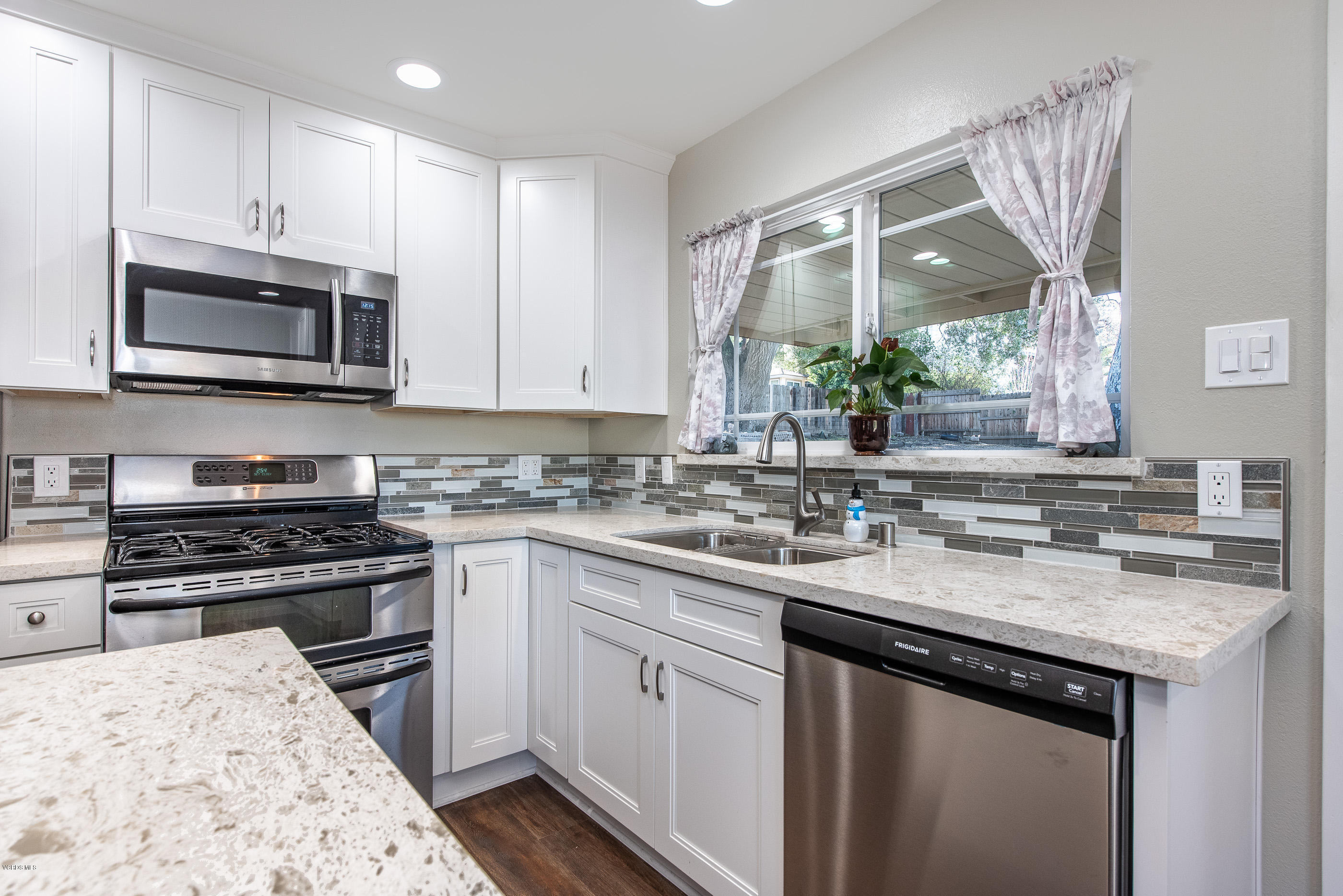 823 Katherine Road Simi Valley, CA 93063 - Photo 7 of 25 a kitchen with stainless steel appliances granite countertop a sink stove microwave and cabinets