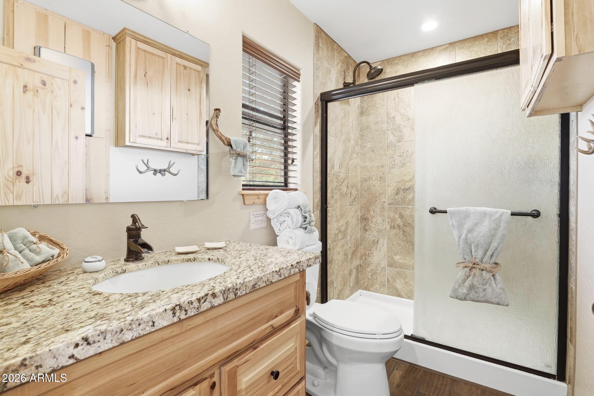 4023 Pine Road Pine, AZ 85544 - Photo 9 of 22 a bathroom with a granite countertop sink toilet and shower