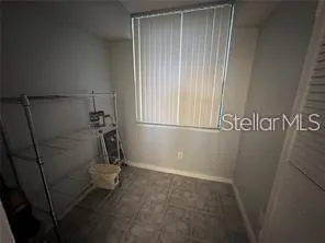 a view of storage and utility room with window