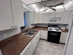 a kitchen with cabinets and appliances