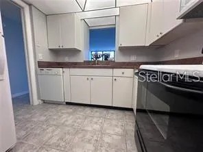 a kitchen with stainless steel appliances granite countertop a sink and a white cabinets