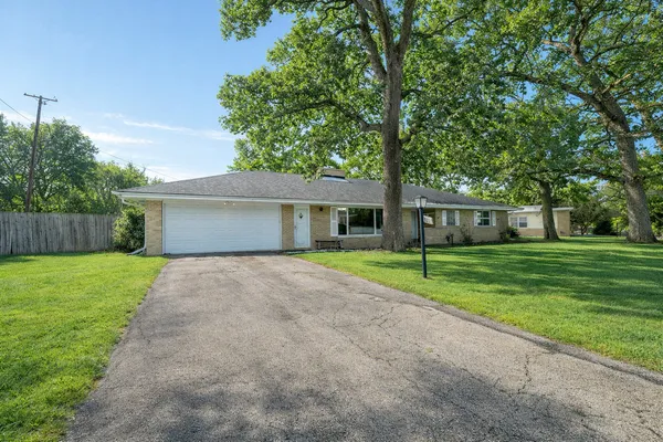a front view of a house with a yard and a garage