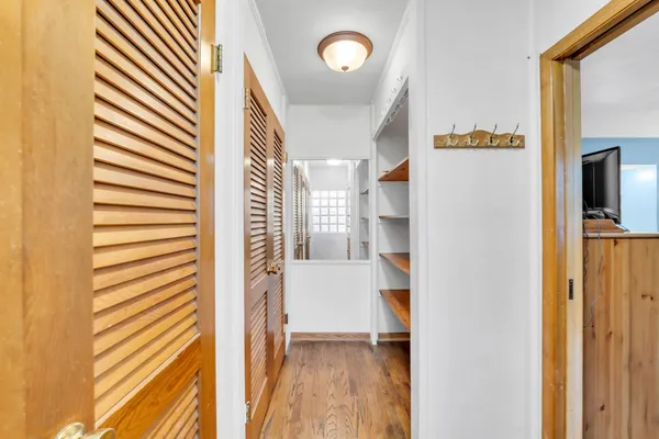 a view of entryway and hall with wooden floor