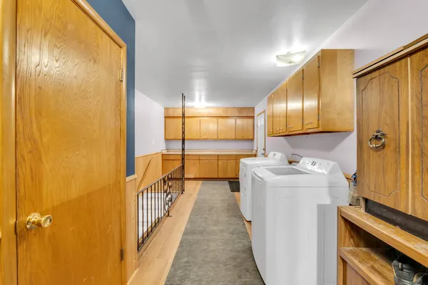 a view of a hallway with wooden shelves