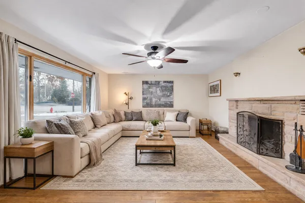 a living room with furniture a rug and a fireplace