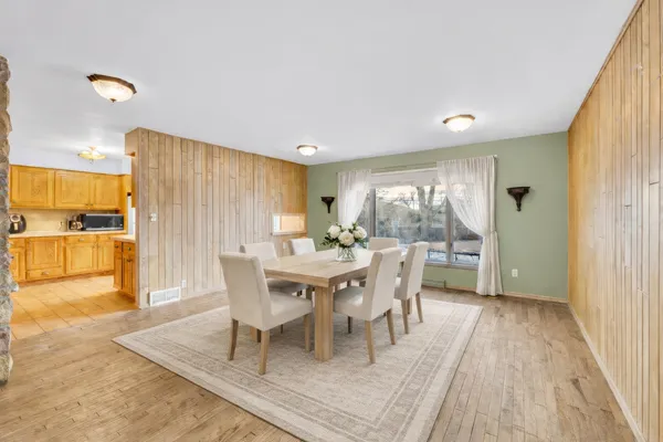 a dining room with furniture and wooden floor