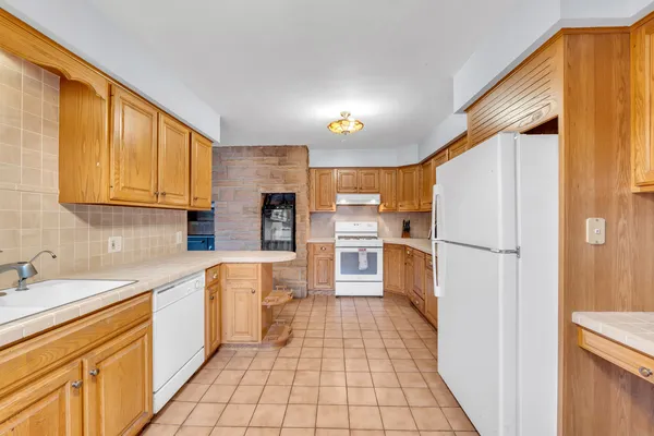a kitchen with white cabinets and white appliances