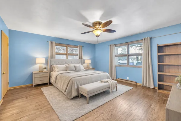 a spacious bedroom with a bed and a window