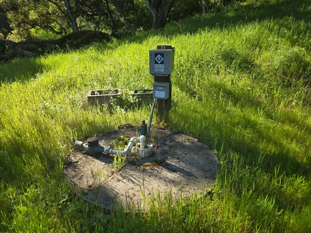 a backyard of a house with lots of green space and lake view