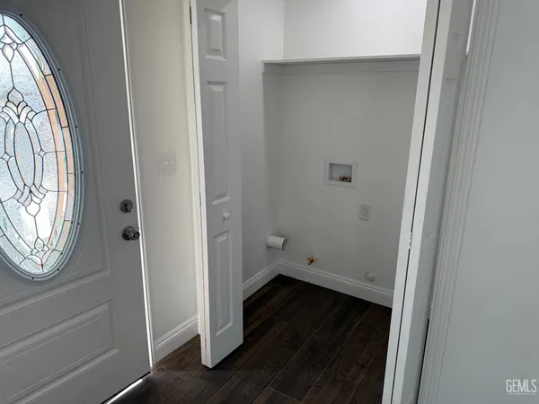 a view of small space with wooden floor and a window