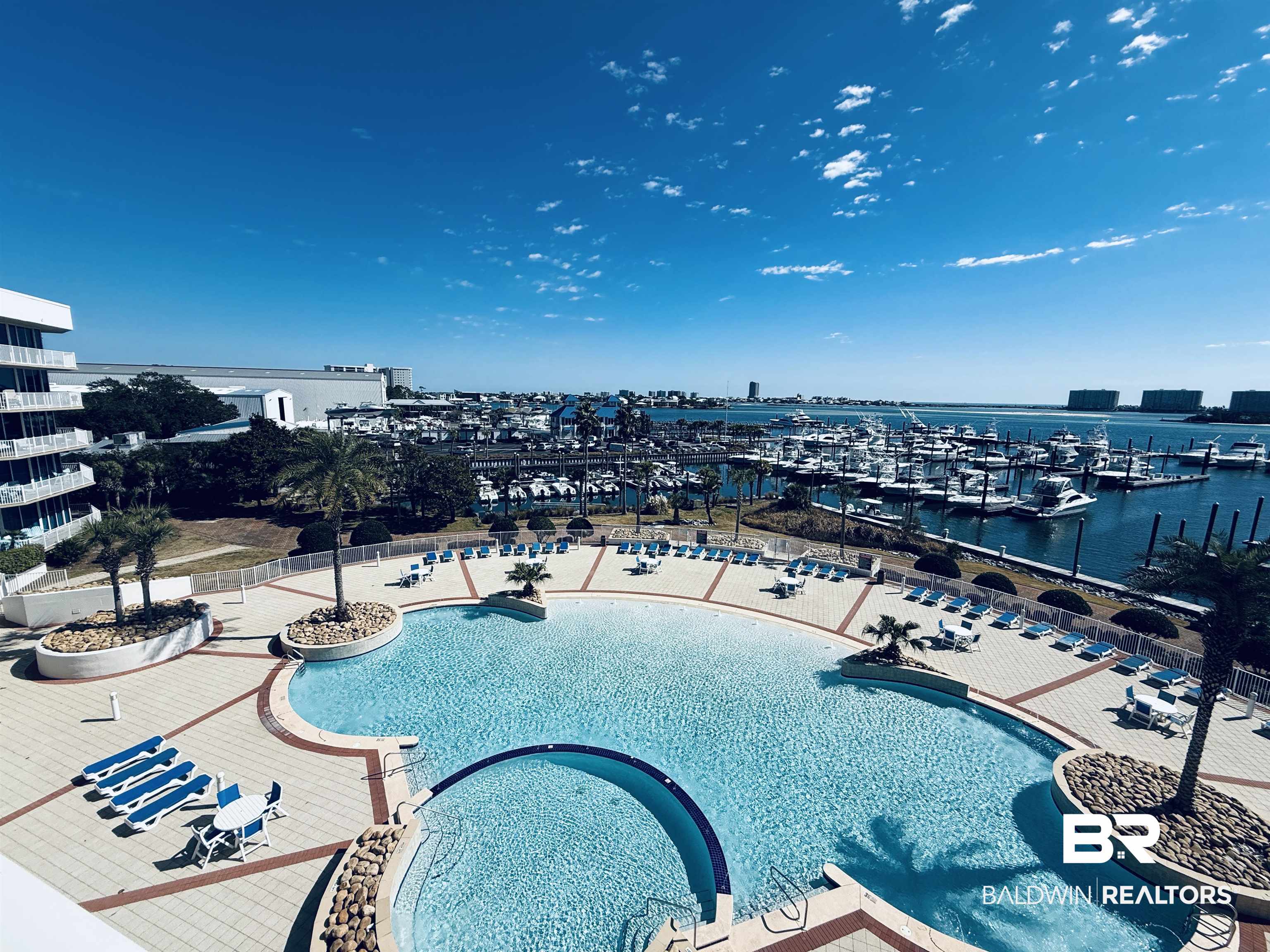 27800 Canal Road, Unit 409 Orange Beach, AL 36561 - Photo 13 of 22 Community pool with a water view and view of marina