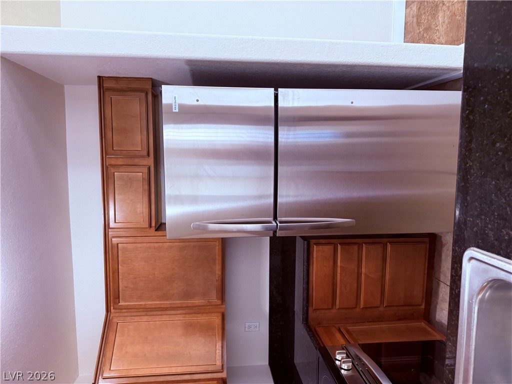 9325 West Desert Inn Road, Unit 260 Las Vegas, NV 89117 - Photo 9 of 42 A well-appointed kitchen showcasing a stainless steel refrigerator and ample cabinetry.