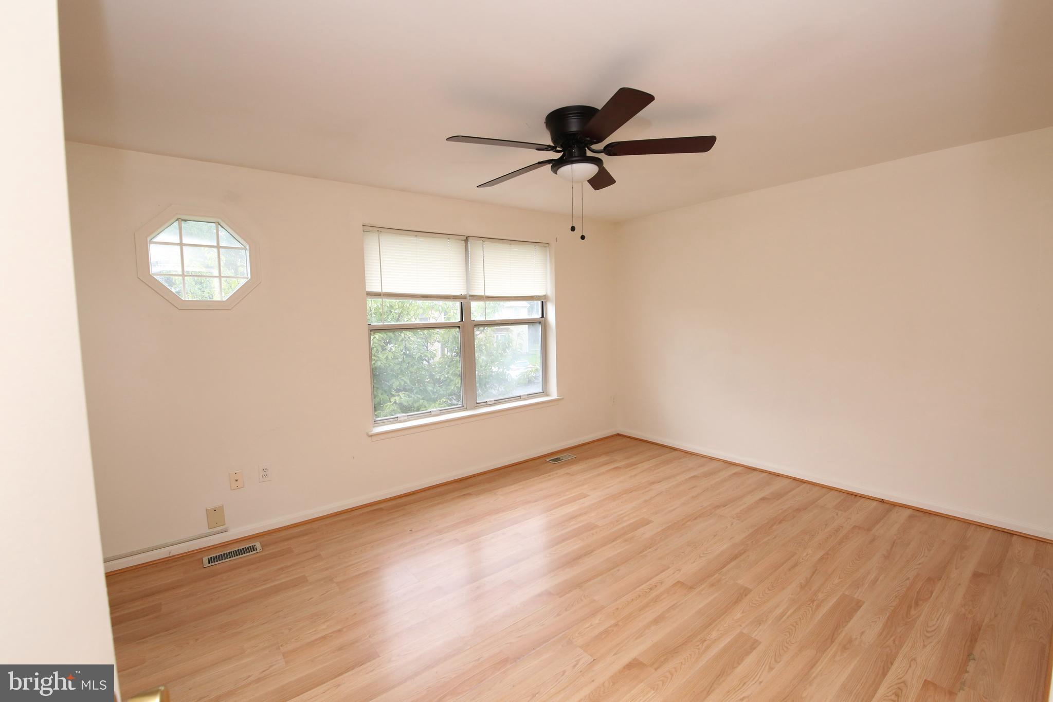 1243 Independence Square Belcamp, MD 21017 - Photo 17 of 19 an empty room with wooden floor fan and windows