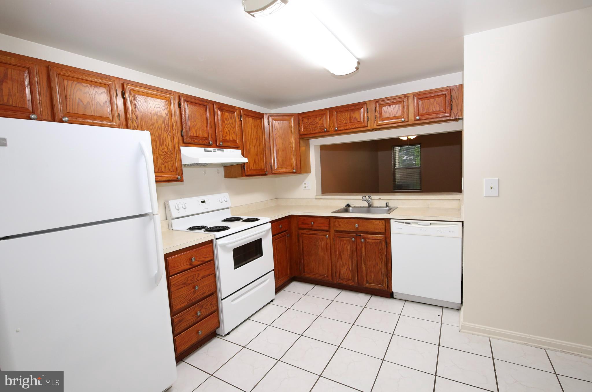 1243 Independence Square Belcamp, MD 21017 - Photo 2 of 19 a kitchen with a stove a microwave and refrigerator