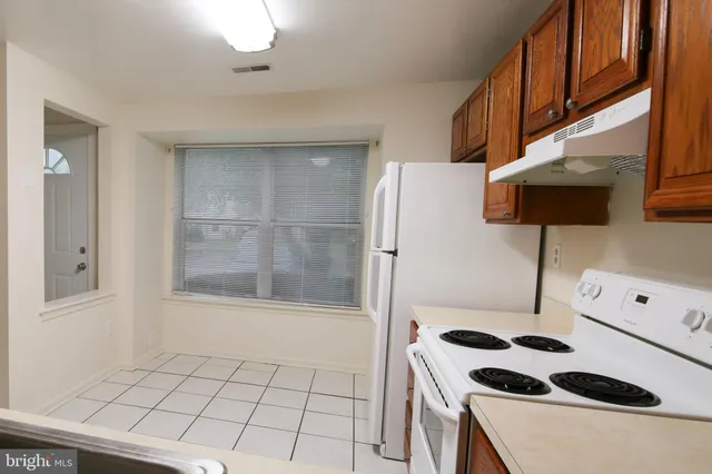 a kitchen with stainless steel appliances a refrigerator and a stove top oven