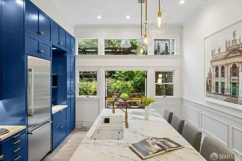 a kitchen with stainless steel appliances granite countertop a stove a refrigerator and a microwave