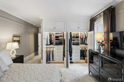a bedroom with furniture and a flat screen tv