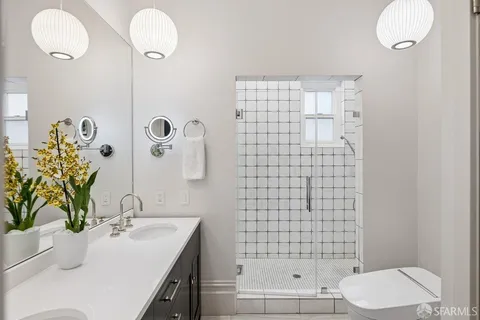 a bathroom with a toilet sink and shower
