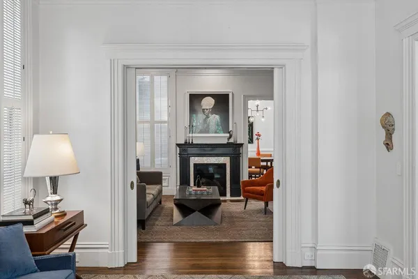 a living room with furniture and a book shelf