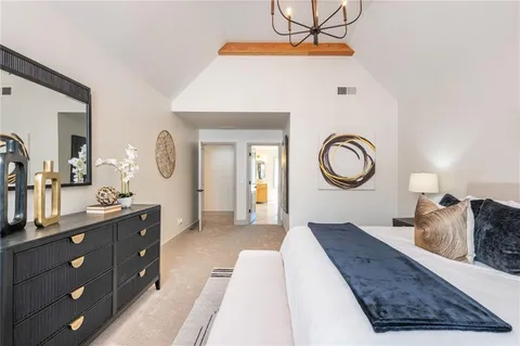 a living room with furniture and a mirror