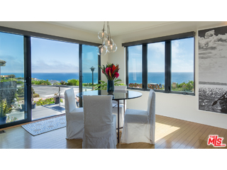 29500 Heathercliff Road, Unit 178 Malibu, CA 90265 - Photo 13 of 35 a living room view with large windows and wooden floor