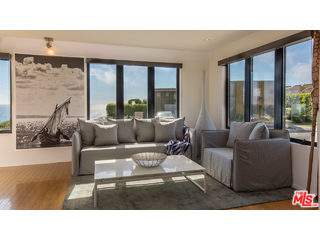 29500 Heathercliff Road, Unit 178 Malibu, CA 90265 - Photo 15 of 35 a living room with furniture and large windows