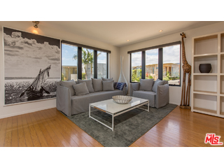 29500 Heathercliff Road, Unit 178 Malibu, CA 90265 - Photo 16 of 35 a living room with furniture wooden floor and a large window