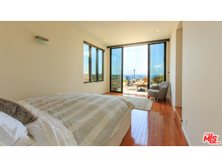 29500 Heathercliff Road, Unit 178 Malibu, CA 90265 - Photo 26 of 35 a living room with a couch and a floor to ceiling window