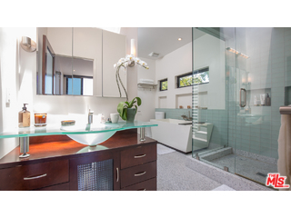 29500 Heathercliff Road, Unit 178 Malibu, CA 90265 - Photo 28 of 35 a bathroom with a sink a mirror and a shower