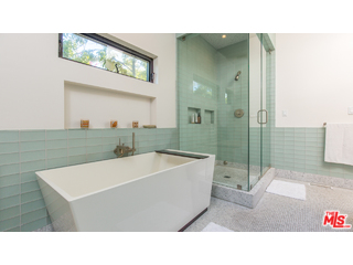 29500 Heathercliff Road, Unit 178 Malibu, CA 90265 - Photo 29 of 35 a bathroom with a sink a mirror and a bathtub