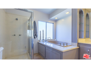 29500 Heathercliff Road, Unit 178 Malibu, CA 90265 - Photo 33 of 35 a bathroom with a sink a mirror and a shower