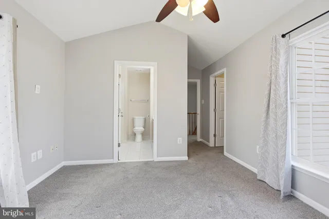 an empty room with chandelier fan
