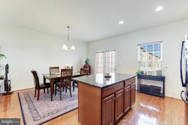 a dining table chairs and chandelier