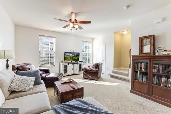 a living room with furniture and a book shelf