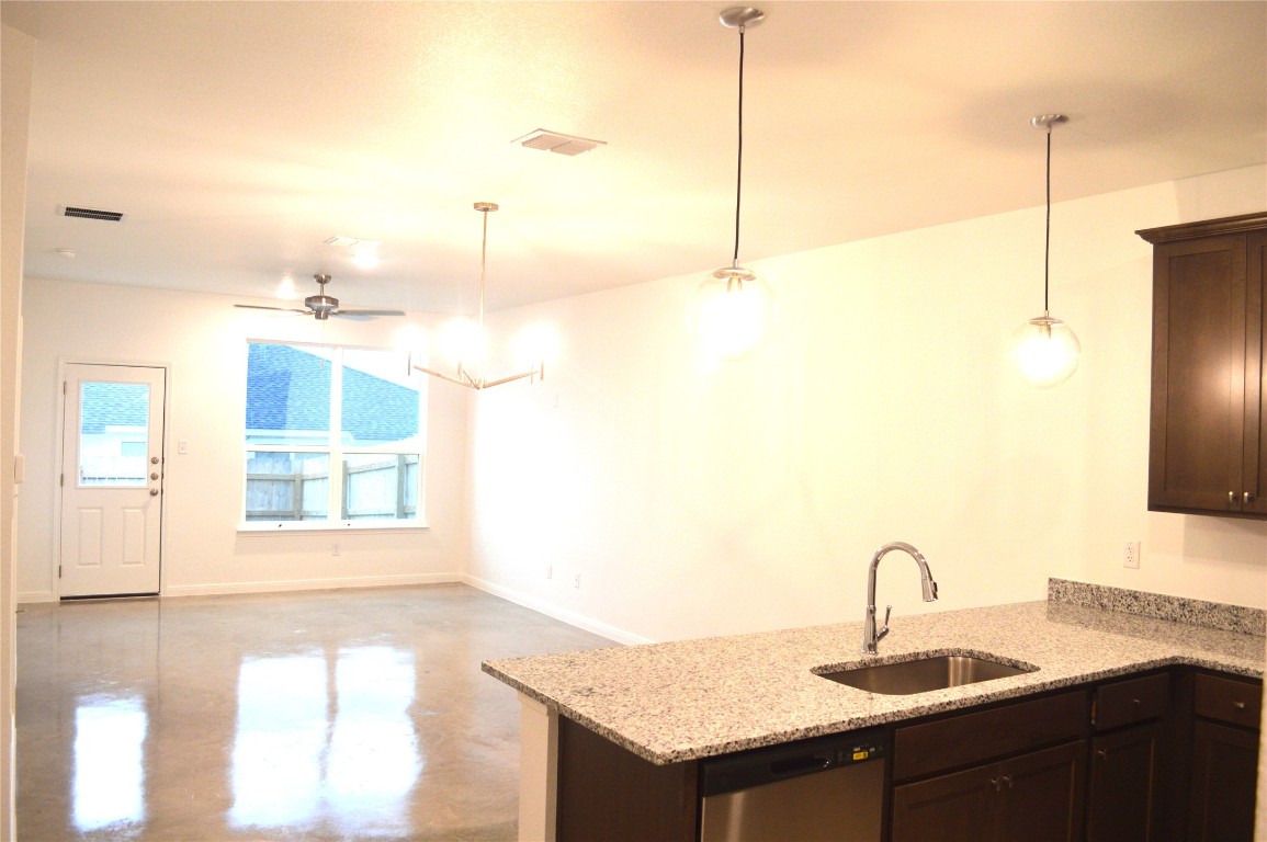 2919 Wildcat Rdg Road, Unit A Temple, TX 76501 - Photo 22 of 22 Kitchen with dark brown cabinetry, a peninsula, concrete flooring, and dishwasher