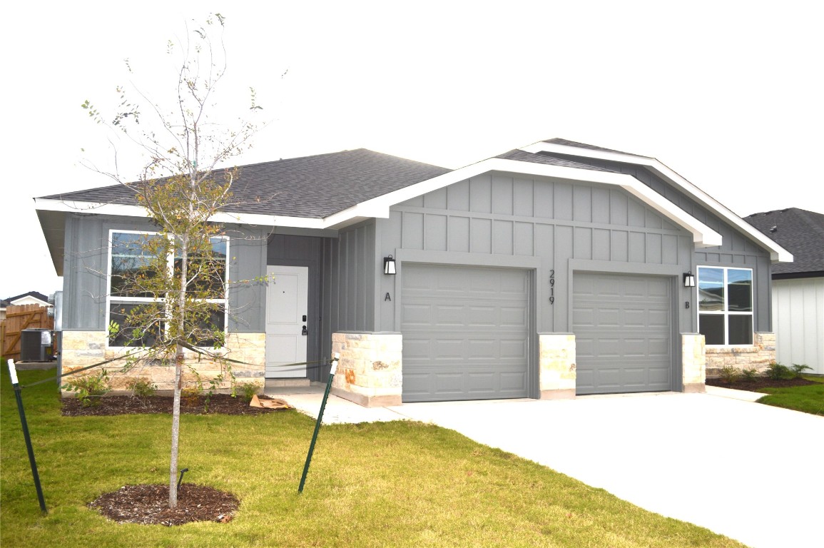 2919 Wildcat Rdg Road, Unit A Temple, TX 76501 - Photo 3 of 22 View of front of home with board and batten siding, stone siding, roof with shingles, and a front lawn