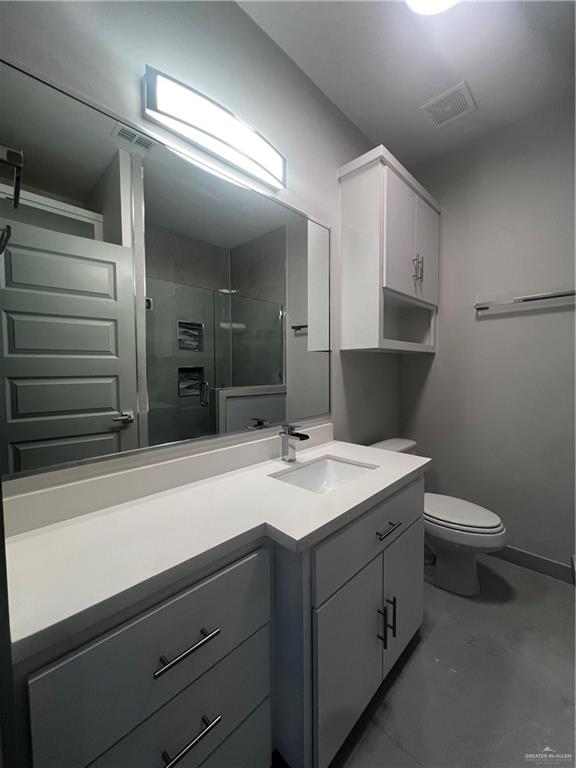 2204 North Jackson Road, Unit A B Edinburg, TX 78541 - Photo 4 of 18 a bathroom with a sink a toilet and vanity