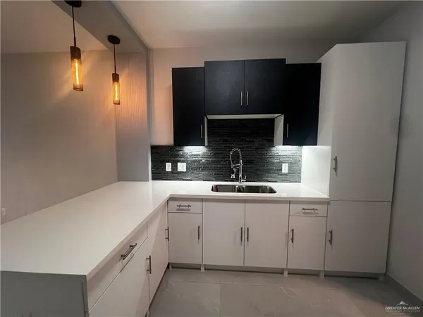 a kitchen with a sink and cabinets