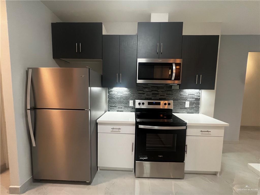 2204 North Jackson Road, Unit A B Edinburg, TX 78541 - Photo 9 of 18 a kitchen with a refrigerator stove and microwave