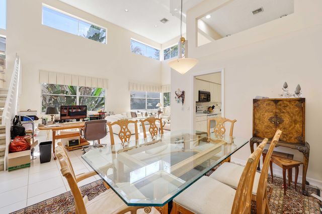 a dining room with wooden floor and large window