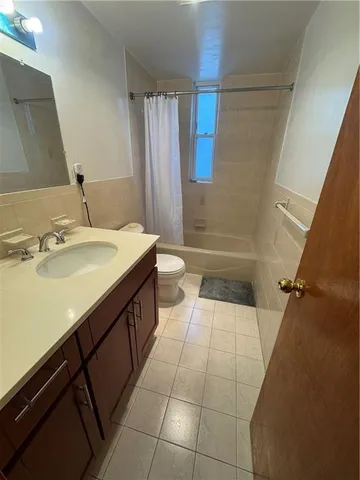 a bathroom with a sink a toilet a mirror and shower